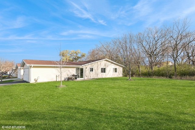 exterior space featuring a garage and a front lawn