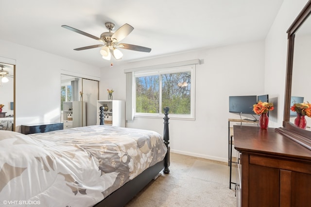 carpeted bedroom with ceiling fan and a closet