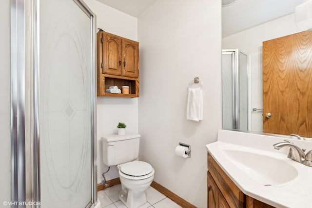 bathroom with tile patterned flooring, vanity, toilet, and a shower with door