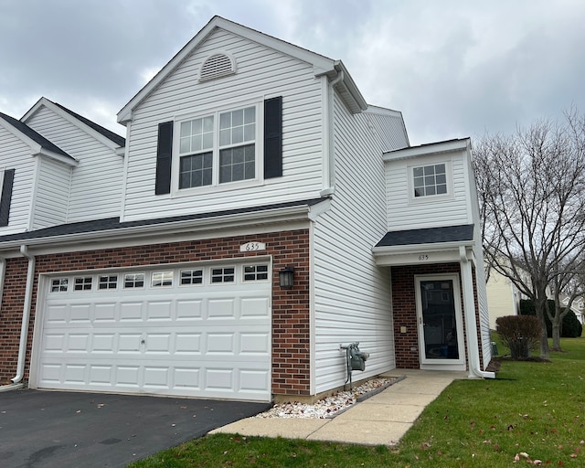 view of front property with a garage and a front yard