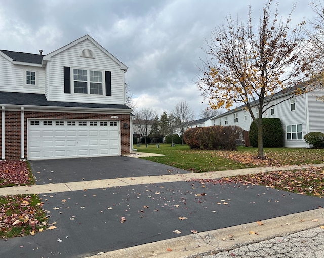 front of property with a garage and a front yard