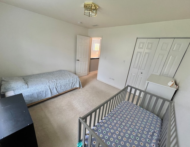 carpeted bedroom with a closet