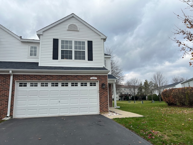 view of front of property with a garage and a front yard