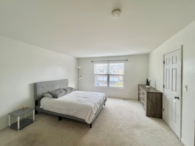 bedroom featuring light colored carpet