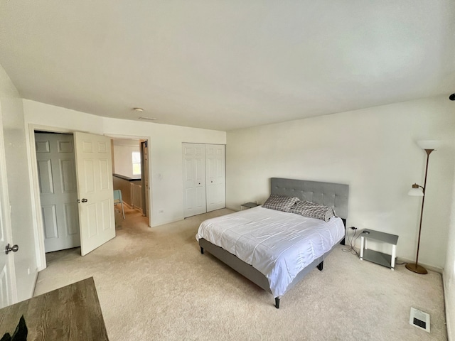 bedroom featuring light colored carpet