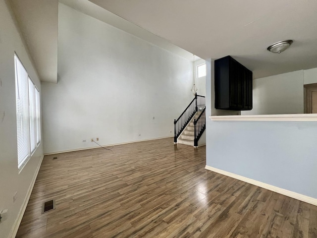 unfurnished living room with dark hardwood / wood-style flooring