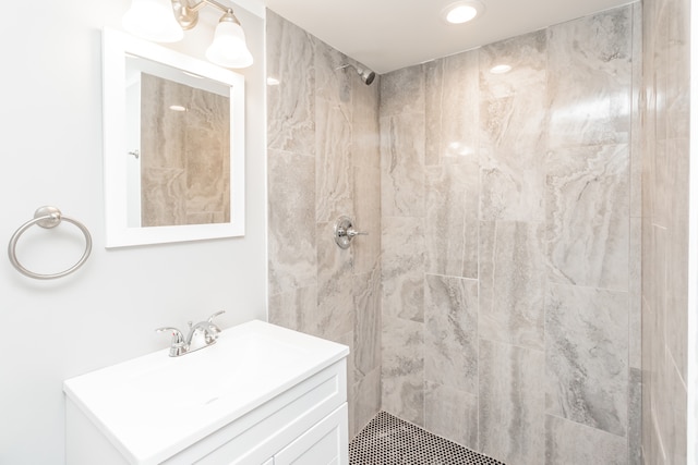 bathroom featuring vanity and a tile shower