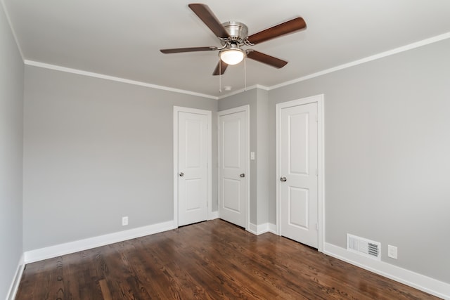 unfurnished bedroom with ceiling fan, dark hardwood / wood-style floors, and ornamental molding