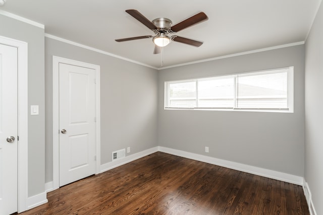 spare room featuring ceiling fan, dark hardwood / wood-style floors, and crown molding