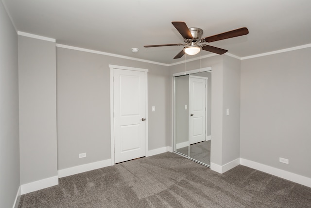 unfurnished bedroom featuring ornamental molding, ceiling fan, and dark carpet