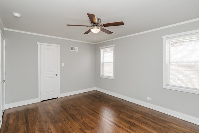 unfurnished room featuring dark hardwood / wood-style flooring, ceiling fan, and crown molding