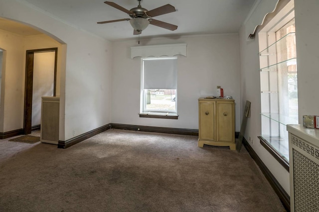 2206 W Lunt Ave, Chicago, IL 60645 - unfurnished room with carpet, arched walkways, a ceiling fan, and crown molding