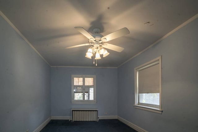 2206 W Lunt Ave, Chicago, IL 60645 - spare room with radiator, crown molding, baseboards, ceiling fan, and dark carpet
