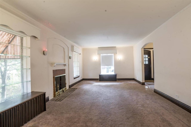 2206 W Lunt Ave, Chicago, IL 60645 - unfurnished living room with carpet flooring, arched walkways, a tiled fireplace, baseboards, and crown molding