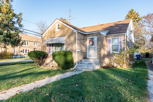 bungalow-style home featuring a front yard