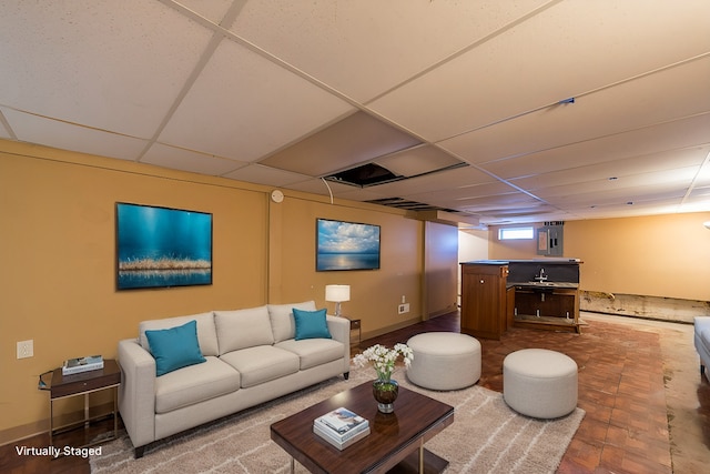 living room with a paneled ceiling