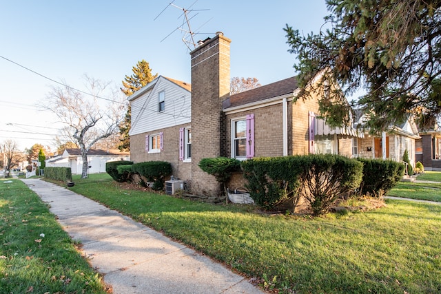 view of home's exterior featuring central AC unit and a lawn