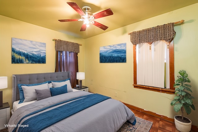 bedroom featuring parquet flooring and ceiling fan