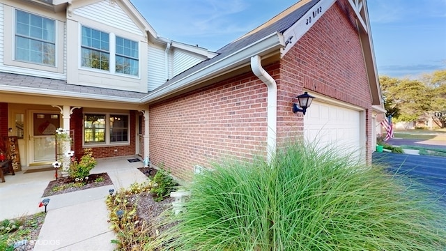 property entrance with a garage and a porch