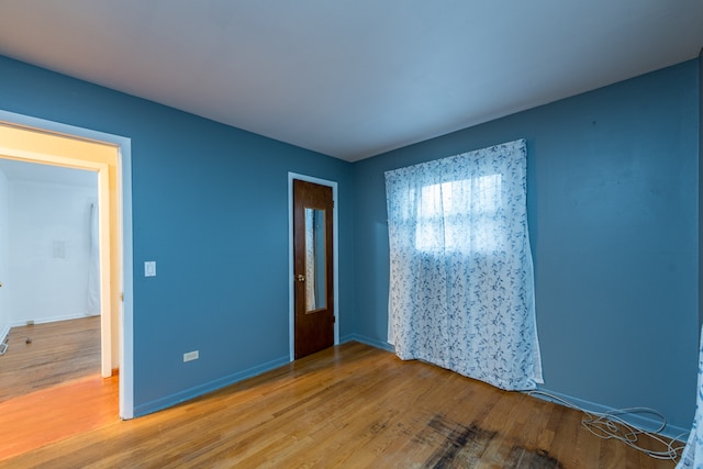 spare room with wood-type flooring