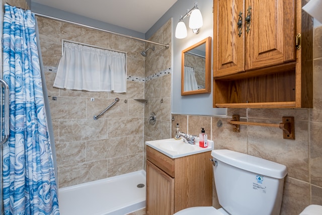 bathroom featuring walk in shower, tile walls, vanity, and toilet