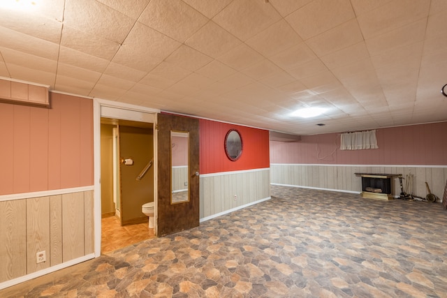 basement featuring wooden walls