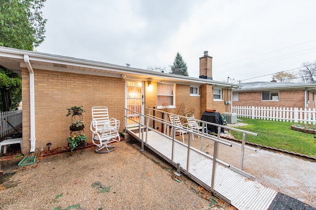 rear view of property featuring cooling unit