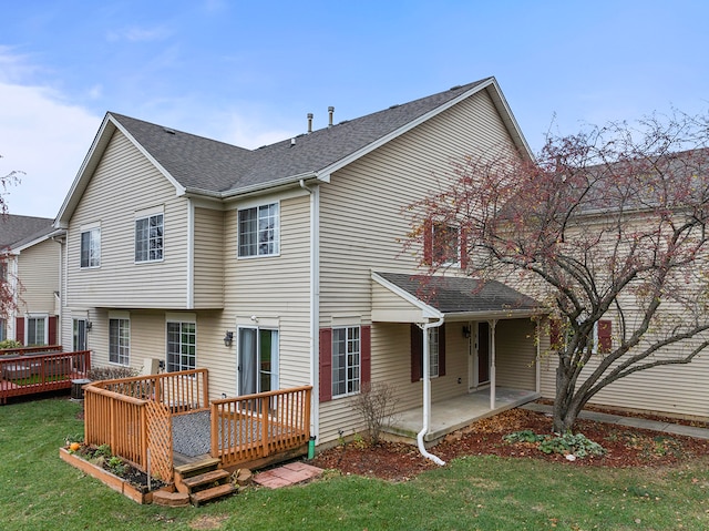 back of property with central air condition unit, a patio area, a lawn, and a wooden deck