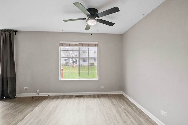 empty room featuring ceiling fan and light hardwood / wood-style flooring