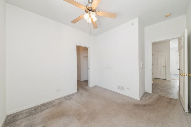 unfurnished room with light colored carpet and ceiling fan