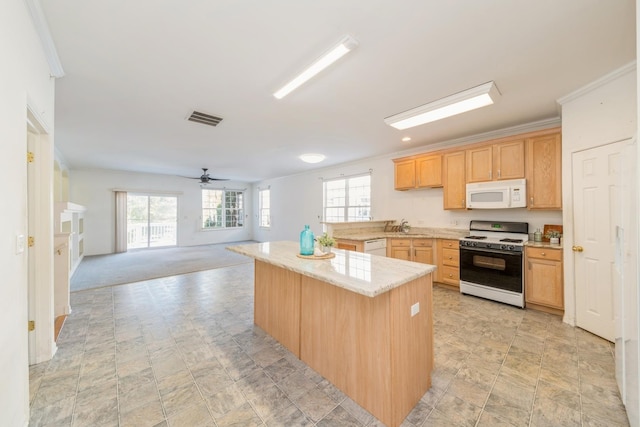 kitchen with light brown cabinets, ceiling fan, crown molding, light carpet, and white appliances