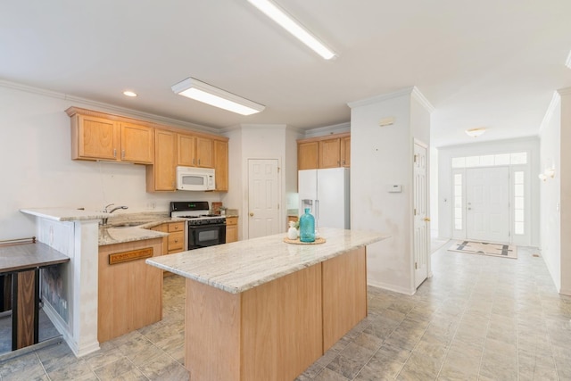 kitchen featuring sink, white appliances, ornamental molding, and a kitchen island