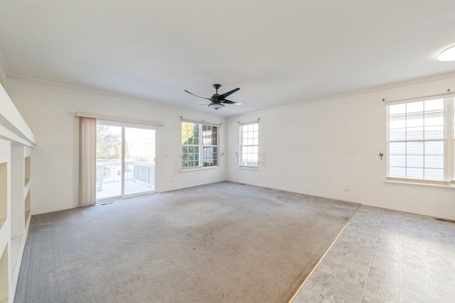 carpeted empty room with ceiling fan and ornamental molding