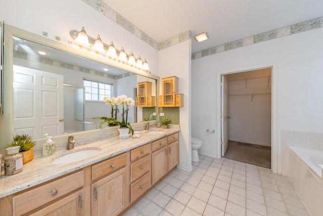 full bathroom featuring vanity, tile patterned floors, shower with separate bathtub, and toilet