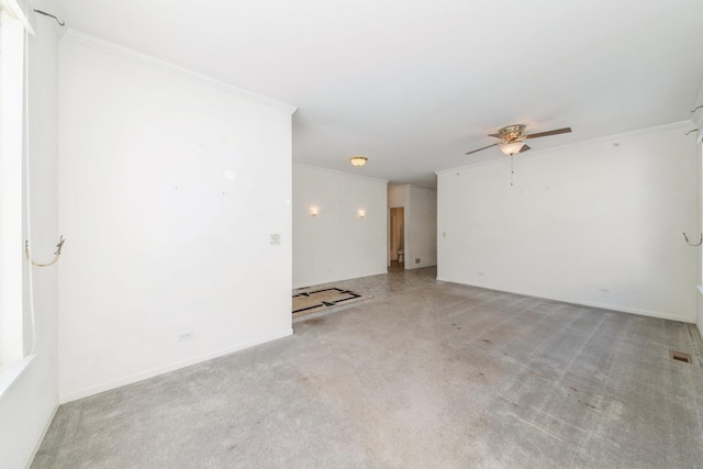 spare room with ornamental molding and ceiling fan