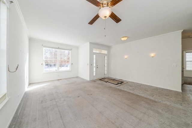 carpeted empty room featuring crown molding and ceiling fan