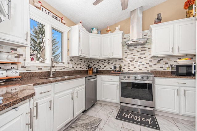 kitchen with white cabinets, sink, wall chimney exhaust hood, a textured ceiling, and appliances with stainless steel finishes