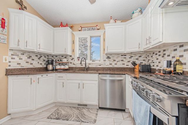 kitchen featuring white cabinetry, sink, stainless steel appliances, and a textured ceiling