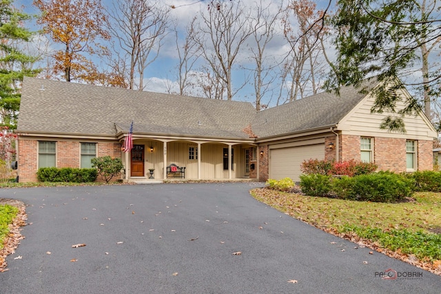 view of front of property with a porch and a garage