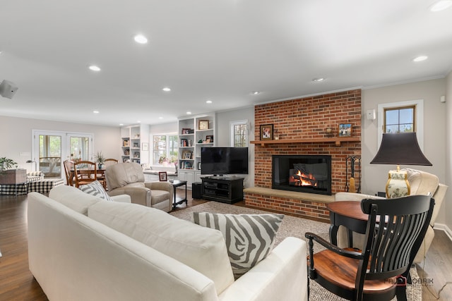 living room featuring a fireplace, french doors, dark hardwood / wood-style flooring, and ornamental molding