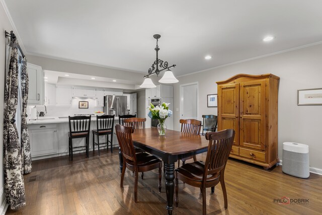 dining room featuring ornamental molding and dark wood-type flooring