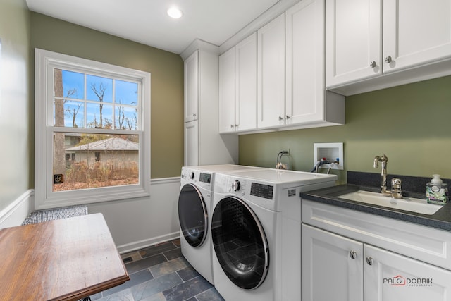 laundry room with cabinets, independent washer and dryer, and sink