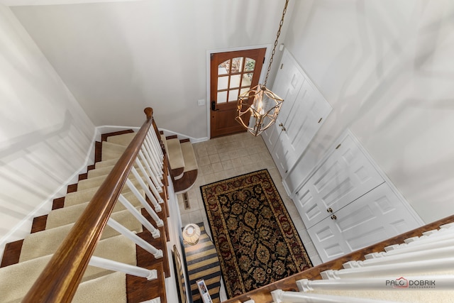 stairway with a chandelier