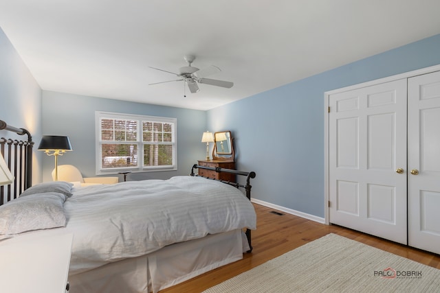 bedroom featuring a closet, light hardwood / wood-style floors, and ceiling fan