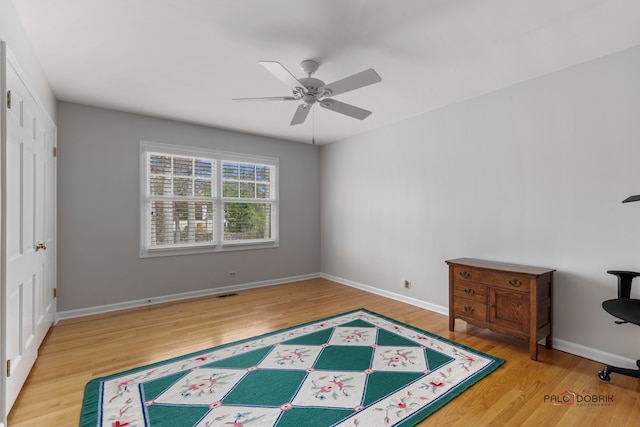 bedroom featuring ceiling fan, wood-type flooring, and a closet