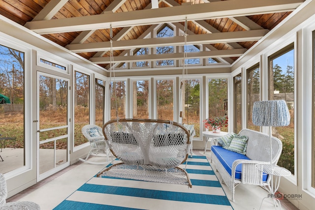 sunroom featuring vaulted ceiling with beams and wooden ceiling