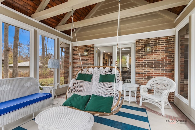 sunroom / solarium with lofted ceiling with beams, wood ceiling, and a wealth of natural light