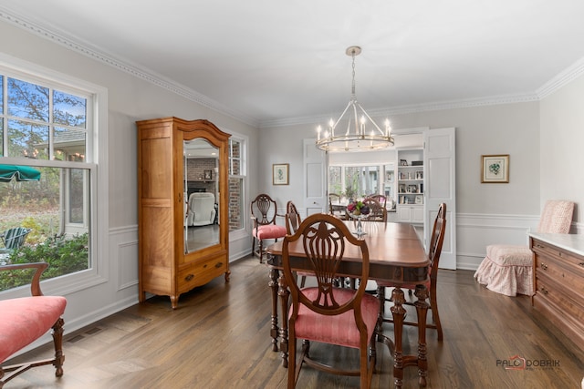 dining space with a chandelier, dark hardwood / wood-style floors, and ornamental molding