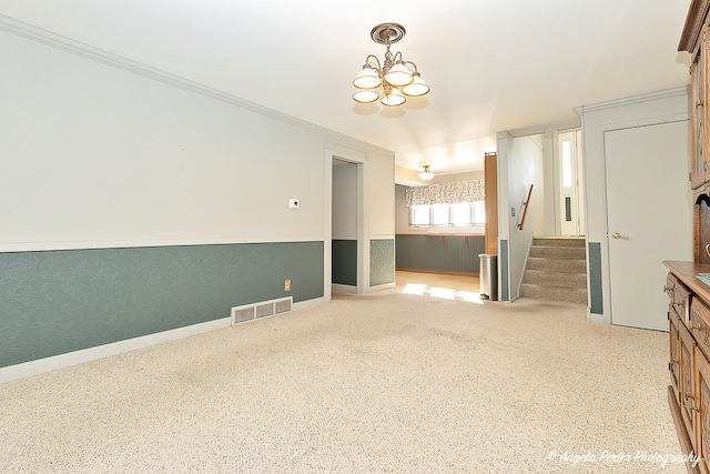 empty room with an inviting chandelier and ornamental molding