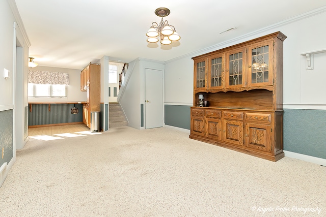 living room with ornamental molding and a chandelier